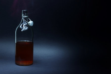 Vintage clear glass bottle on black backgrounds.の写真素材