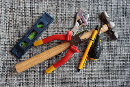 A set of tools used for household chores, spirit level, adjustable wrench, pliers, hammer,...
