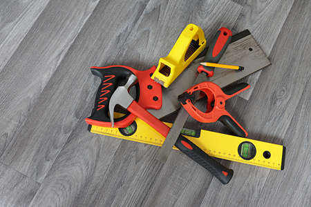Home set of carpentry tools, saw, spirit level, file, hammer, pencil, spring clamp, block planer.
