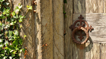 Old wooden door and old rusty knocker in Ireland.