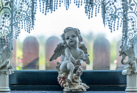 A figurine of a winged little Bacchus with a happy faceのeditorial素材