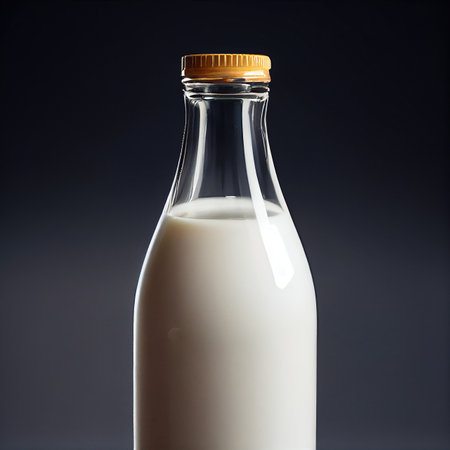 Closed Glass Milk bottle isolated on dark background.の写真素材