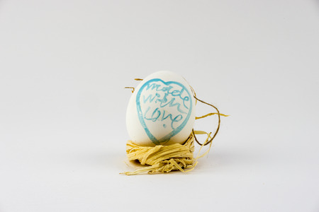 Hand painted Easter Eggs in a raffia nest.