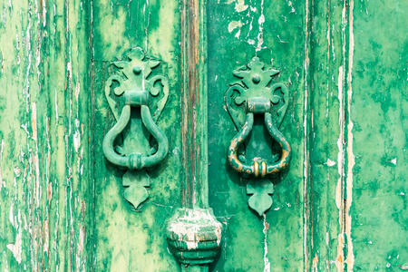 Colorful door with door knockers in a typical Portugese houseの写真素材