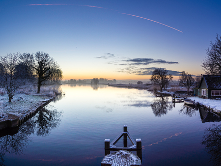 Sunrise over Penningsveer in the Netherlands during  a cold but sunny morningの写真素材