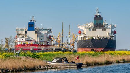 Two tankers in Amsterdam harbor and a small private vesselの写真素材