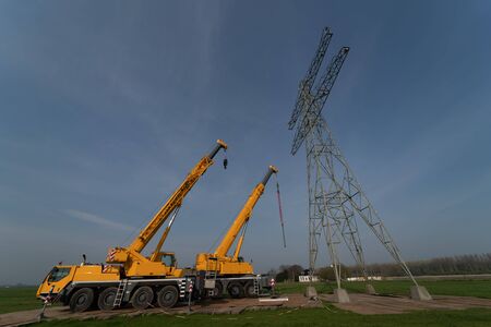 Removing old electricity pylons requires heavy equipment