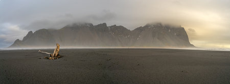 Vestrahorn, a 454 meter tall scree mountain, seen during the very early hours of the day over sunrise at the Stokksnes peninsula in southern Icelandの写真素材