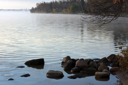 Early morning mist on a bay in the lakeの写真素材