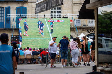 At Perigueux, Dordogne, France June 03 2023: United in Sports: Spectators Watching a Rugby Match Broadcast in a Public Squareのeditorial素材