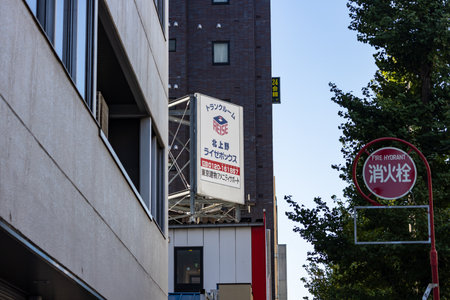 Tokyo, Japan, October 26, 2023: Advertising Signboard on a Building Next to a Fire Hydrant Signのeditorial素材
