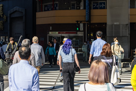 Tokyo, Japan, October 26, 2023: Pedestrians crossing street in business districtのeditorial素材