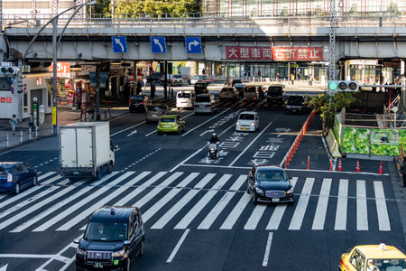 Tokyo, Japan, October 26, 2023: Traffic at a Major Intersection with Overpass