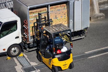 Tokyo, Japan, October 26, 2023: Forklift Loading Cardboard Boxes onto a Freight Truckのeditorial素材