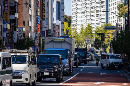 Tokyo, Japan, October 26, 2023: Traffic on a Main Road with Urban Skylineのeditorial素材