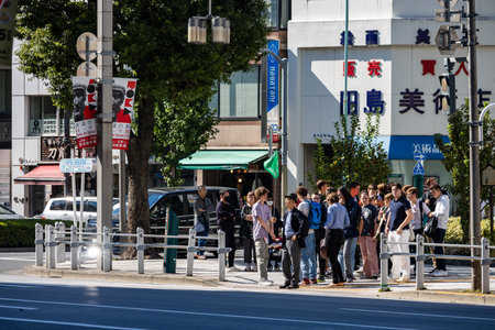 Tokyo, Japan, October 26, 2023: Crowd of people waiting at a pedestrian crossing