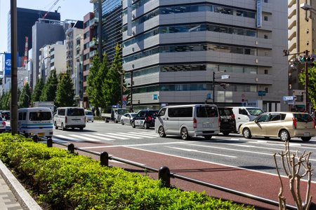 Tokyo, Japan, October 26, 2023: Busy street scene with cars and city life during daytime