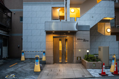 Tokyo, Japan, October 28, 2023: Modern Apartment Building Entrance at Duskのeditorial素材
