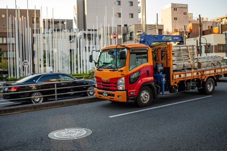 Tokyo, Japan, October 28, 2023: Orange Truck on the City Streetのeditorial素材