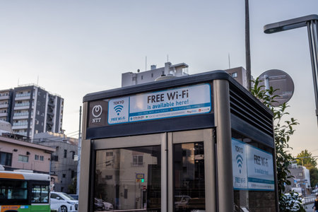 Tokyo, Japan, October 28, 2023: Public Phone Booth with Free Wi-Fi Signのeditorial素材