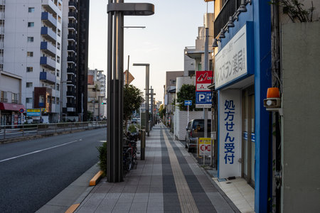 Tokyo, Japan, October 28, 2023: Quiet Street View with Sidewalk and Shopsのeditorial素材
