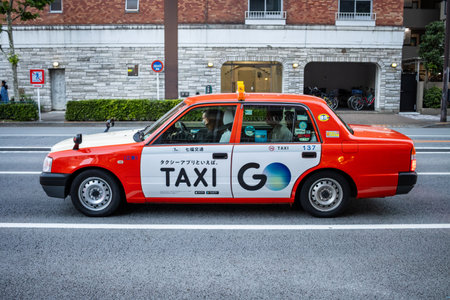 Tokyo, Japan, October 28, 2023: Red Taxi Cab on Tokyo Streetのeditorial素材