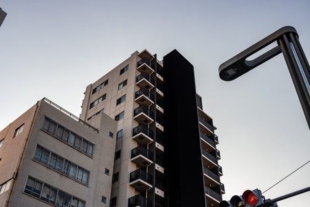 Tokyo, Japan, October 28, 2023: Modern Buildings and Street Lamp at Duskのeditorial素材
