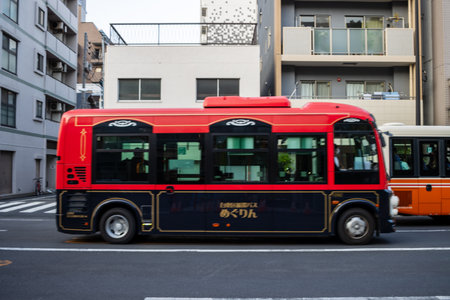 Tokyo, Japan, October 28, 2023: Red Electric Bus Parked at a Bus Stop