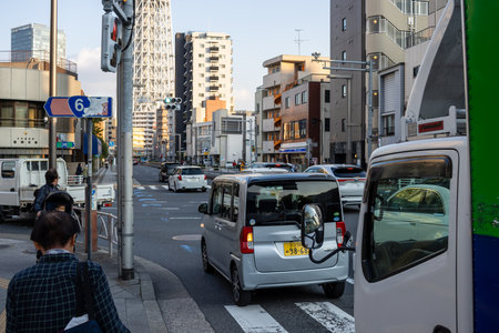 Tokyo, Japan, October 28, 2023: Busy City Street with Vehicles and Pedestriansのeditorial素材