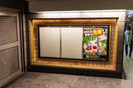 Tokyo, Japan, October 29, 2023: Food advertisement in subway station corridorのeditorial素材