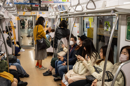 Tokyo, Japan, October 29, 2023: Passengers on a Tokyo subway trainのeditorial素材