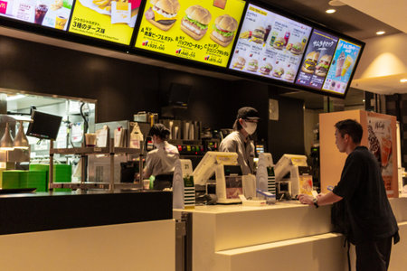 Tokyo, Japan, October 29, 2023: Customer placing an order at a fast food restaurant counterのeditorial素材