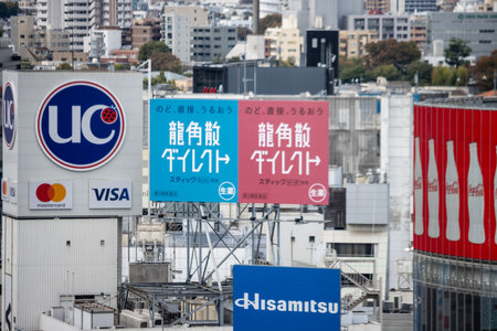 Tokyo, Japan, October 29, 2023: Corporate billboards and logos on urban high-rise buildingsのeditorial素材