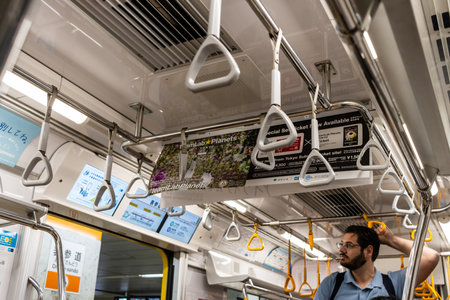Tokyo, Japan, October 29, 2023: Passenger holding the handrail in a subway trainのeditorial素材