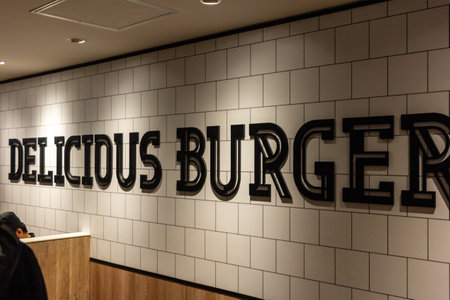 Tokyo, Japan, October 29, 2023: Delicious Burger wall decor in a fast food restaurantのeditorial素材