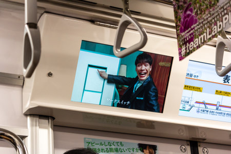 Tokyo, Japan, October 29, 2023: Entertainment advertisement inside a subway trainのeditorial素材