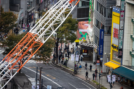 Tokyo, Japan, October 29, 2023: Construction crane over city street near shopping districtのeditorial素材