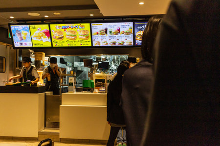 Tokyo, Japan, October 29, 2023: Order counter at a fast food restaurant with digital menusのeditorial素材