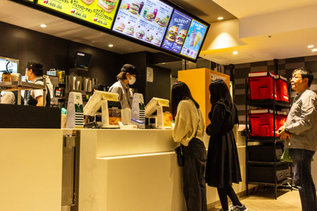 Tokyo, Japan, October 29, 2023: Customers waiting in line at a fast food restaurantのeditorial素材