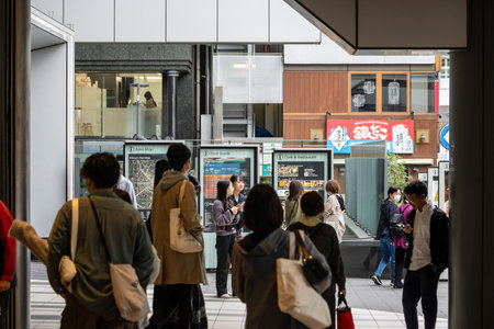 Tokyo, Japan, October 29, 2023: View from a shop entrance onto a busy street with pedestrians and shopsのeditorial素材