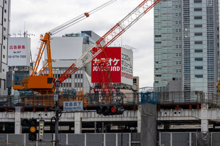 Tokyo, Japan, October 29, 2023: Construction cranes and signage at a high-rise development projectのeditorial素材