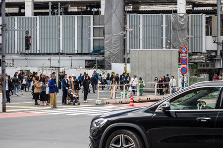 Tokyo, Japan, October 29, 2023: Crowd of people walking near a construction area in the cityのeditorial素材