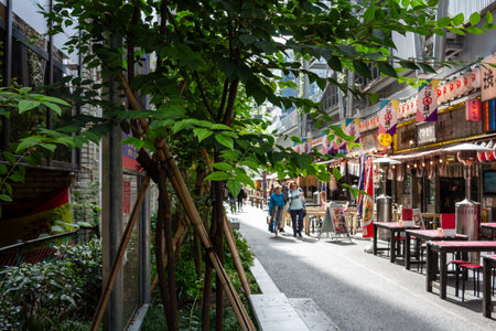 Tokyo, Japan, October 29, 2023: Alleyway in Tokyo with lush greenery and dining spotsのeditorial素材