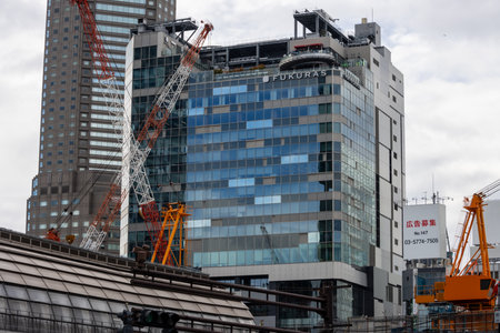 Tokyo, Japan, October 29, 2023: Construction cranes at a high-rise building site in the cityのeditorial素材