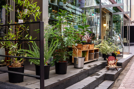 Tokyo, Japan, October 29, 2023: Urban cafe exterior with lush plant decorationsのeditorial素材