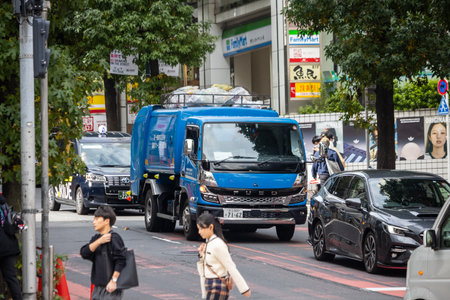 Tokyo, Japan, October 29, 2023: Blue Delivery Truck on Busy Tokyo Streetのeditorial素材