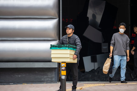 Tokyo, Japan, October 29, 2023: Delivery Worker in Tokyoのeditorial素材