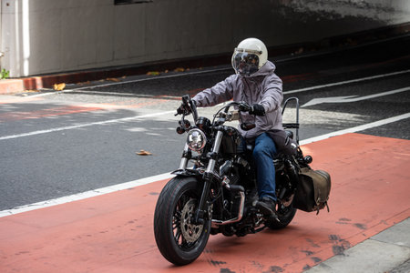 Tokyo, Japan, October 29, 2023: Motorcyclist Riding on City Streetのeditorial素材