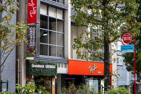 Tokyo, Japan, October 29, 2023: Street View with Multiple Retail Stores Including Ray-Banのeditorial素材