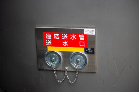 Tokyo, Japan, October 29, 2023: Fire Hose Connection on Building Wallのeditorial素材